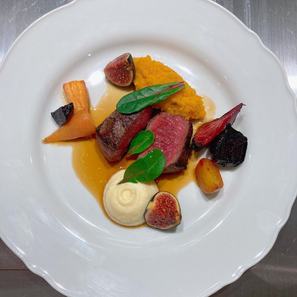 Plated venison loin with fig and root vegetables