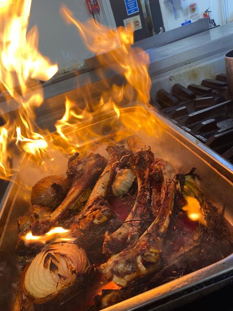 Venison bones and stock over an open flame